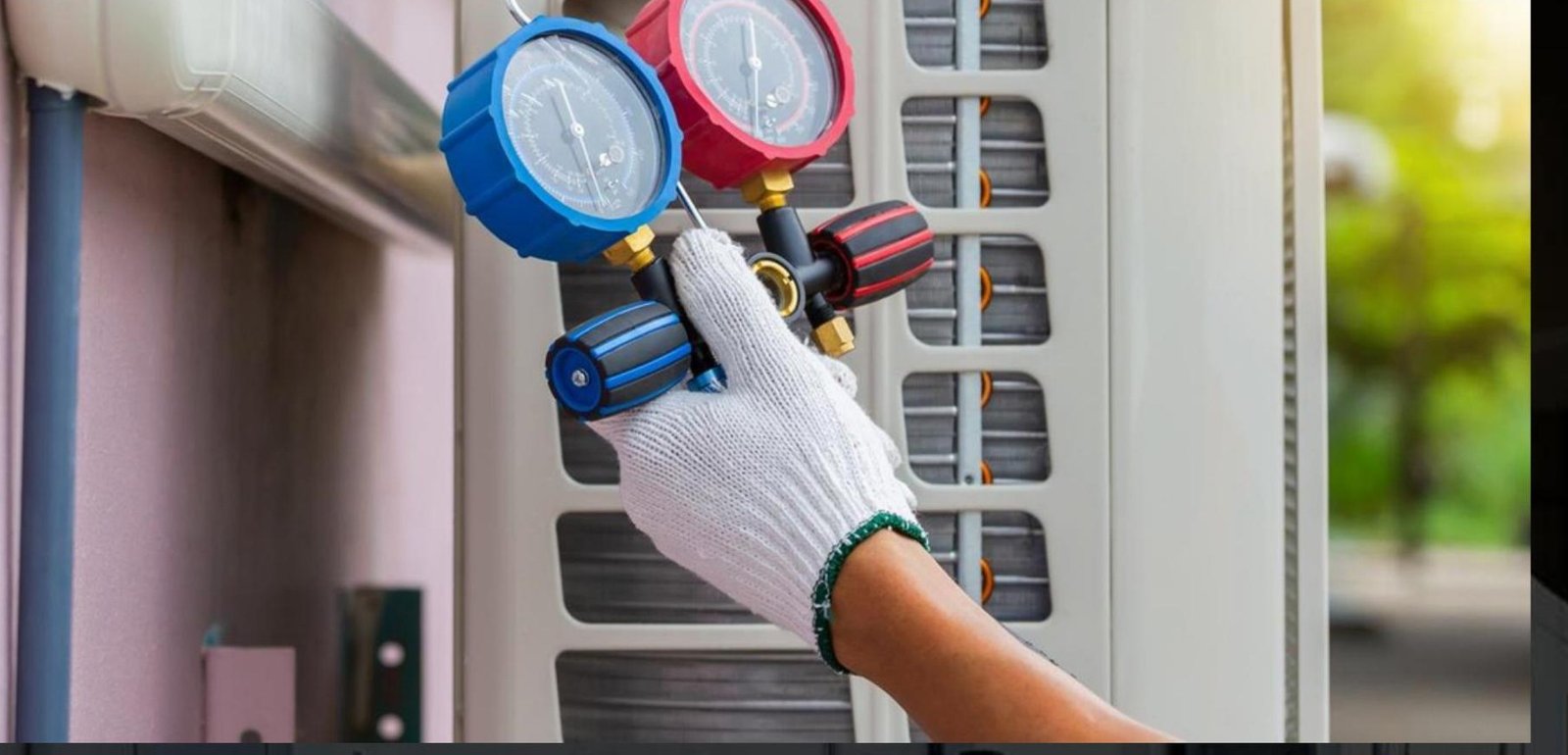 Technician performing maintenance with refrigerant gauges on an HVAC unit